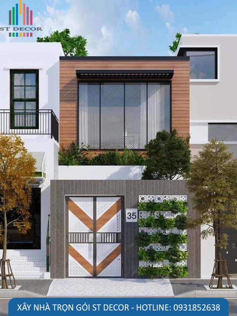 Mẫu nhà thiết kế đơn giản với tông màu trầm có sử dụng cây kết hợp làm tường rào